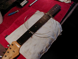 Frets are radiused to fit the radius of the board.